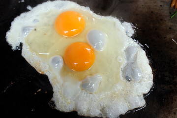 Two fried eggs in a pan.  Breakfast.  Paris.  France.