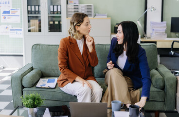 Diverse professionals collaborate on project data analysis, and teamwork in modern office.