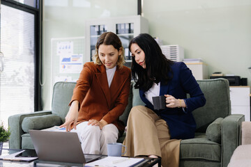 Diverse professionals collaborate on project data analysis, and teamwork in modern office.