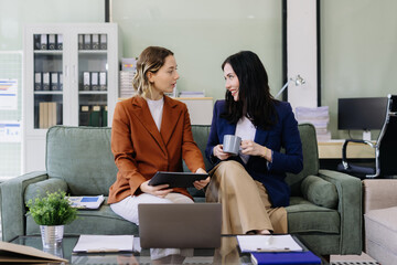 Diverse professionals collaborate on project data analysis, and teamwork in modern office.