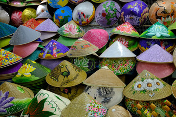 Paddy hats or conical straw hats for sale at a market stall in Dong Ba market. The conical hat is a great symbol of Vietnam.  Hue. Vietnam.