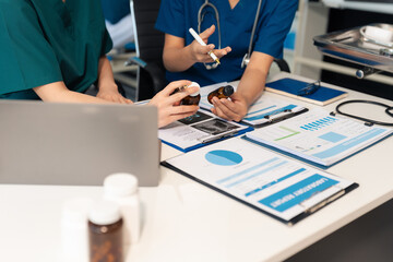 Pharmacists or doctors study information about tablets in the room.