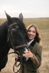 Obraz premium Smiling Woman With Black Horse in Open Field During Daytime