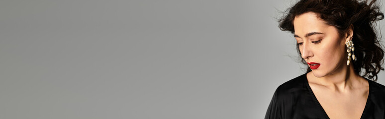 Obraz premium Brunette beauty in elegant attire posing gracefully in a serene studio environment