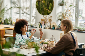 Friends create vibrant succulent arrangements at a creative workshop space filled with plants