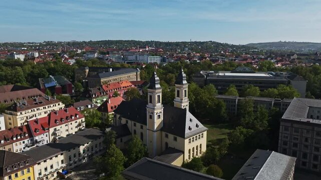 Aerial drone view of St. Stephan's Church in W&uuml;rzburg, Germany, highlighting its stunning architecture and surrounding cityscape. 