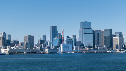 Naklejka premium Tokyo cityscape under the blue sky in a sunny day and Tokyo Tower standing in the middle of the buildings