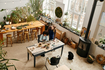 Engaging friends at a lively workshop creating beautiful succulent arrangements together