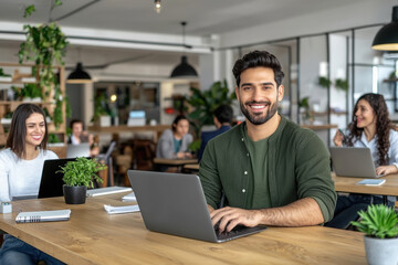 young Indian entrepreneur working on laptop at office