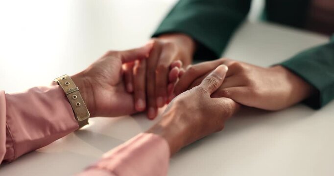 Empathy, hope and friends holding hands for support, kindness or care with cancer diagnosis in home. Trust, comfort or people closeup for connection, love or console together with compassion on table