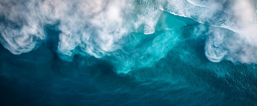 Aerial view of ocean water with swirling foam and gentle waves, creating a dynamic, abstract pattern. The image symbolizes the fluidity and energy of the natural sea.