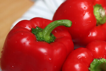 Red bell peppers close up. Shallow depth of field. Fresh vegetables on a table. 