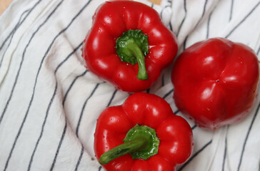 Red bell peppers close up. Shallow depth of field. Fresh vegetables on a table. 