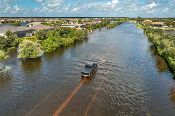 Hurricane rainfall flooded road. Drowned car on city street in Florida residential area....
