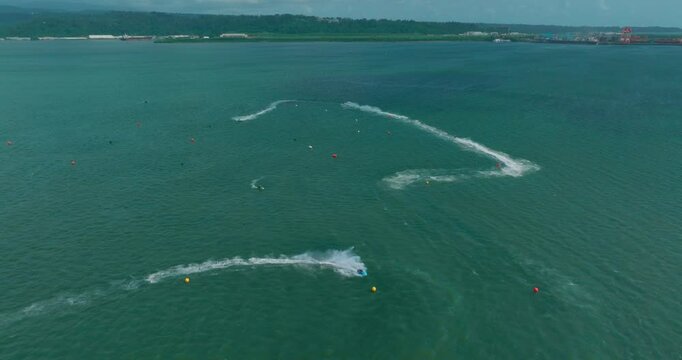 A wide drone shot showcases the vast Subic ocean, highlighting the exciting jet ski course carved into the shimmering blue waters.