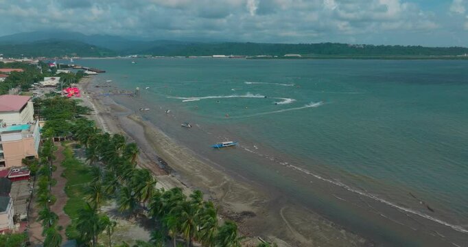 A wide drone shot captures the vast Subic ocean, with jet skis slicing through the waves and boats cruising under the open sky.