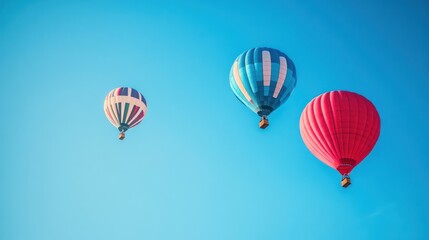 Fototapeta premium red , blue, white color hot air balloons flying in a clear blue sky. Vintage style, wide-angle, copy space concept.