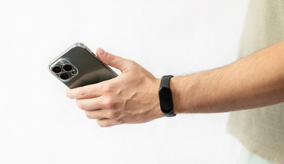 Close-up shot of man with smart band using smartphone isolated on white background