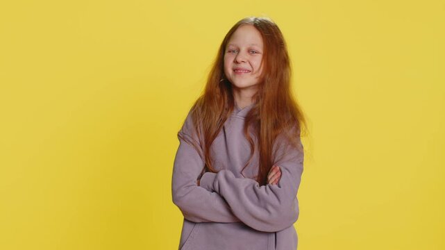 Look at advertisement, subscribe. Preteen child girl kid pointing down, gesturing ok and like, showing place for commercial, promotional information below. Teenager children on yellow background