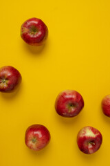 Flat lay composition with many red apples on yellow background. Space for text. High quality photo