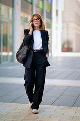 Woman wearing business casual and walking in central business district