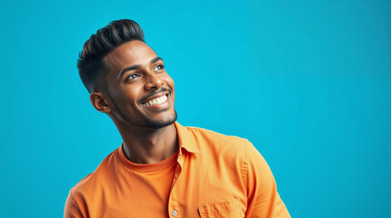 Obraz premium Happy young African American man standing isolated on blue background advertising shopping promotion, presenting product promo looking away at copy space