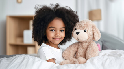 Curly-haired African-American girl playing with a plush puppy on a bed in a bright, cozy room. An atmosphere of serenity and affection.