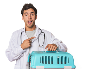 Young Hispanic man as vet with cage pointing to the side