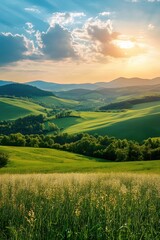 Rolling hills of green landscape with sunlight and clouds in the sky at golden hour