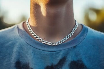 Close-up of a silver cuban link chain on a person. Perfect for fashion, jewelry, or men's style websites.
