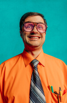 Retro portrait of a smiling nerdy engineer with glasses and an orange shirt