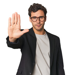 Young Hispanic businessman standing with outstretched hand showing stop sign, preventing you.
