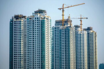 Fototapeta premium A tall building with a crane in the background