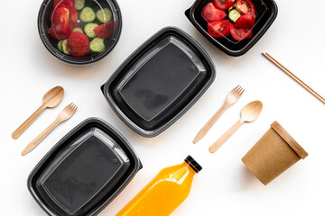 Takeaway food - tomatoes salad in catering boxes, top view. Food delivery concept.