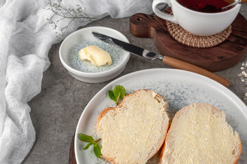 Quick breakfast, bread and butter. Shot on a concrete table in vintage style.