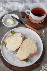 Quick breakfast, bread and butter. Shot on a concrete table in vintage style.
