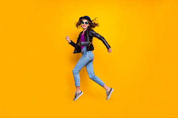 Full body profile side photo of cheerful dreamy jum run enjoy soring weekends wear good look denim jeans isolated over yellow bright color background