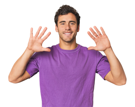 Young Hispanic man in studio showing number ten with hands.