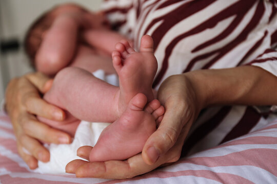 Mother holding baby daughter in arms