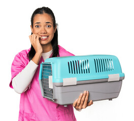 Young Filipina vet holding pet carrier biting fingernails, nervous and very anxious.