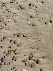 little stones pressed into the sand on the beach of the Baltic Sea