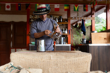 A person making coffee using the infusion method in Salento, Colombia