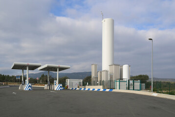 LNG and CNG tank station under cloudy sky
