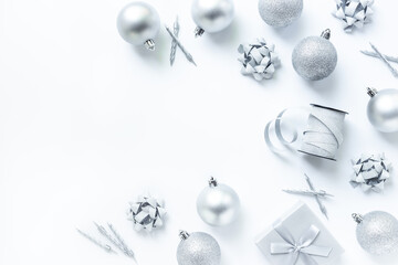 Silver colored Christmas and New Year decorations on white background, top view