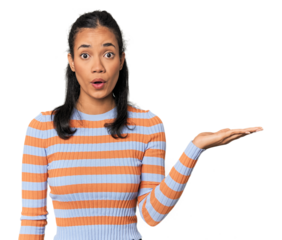 Young Filipina woman impressed holding copy space on palm.