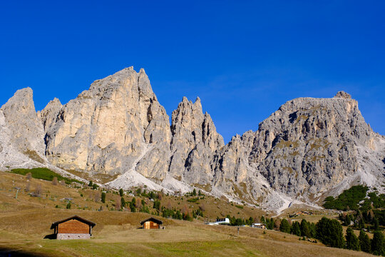Cirs Spitzen peaks at Gr�dner Joch in Gr�dnertal, Dolomites, South Tyrol, Italy with cabins and blue sky