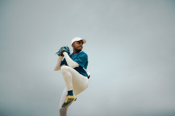 Baseball player in mid-pitch poised on the field capturing the intensity and focus of the game