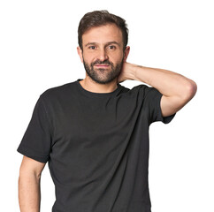 Fototapeta premium Studio portrait of young Hispanic male touching back of head, thinking and making a choice.
