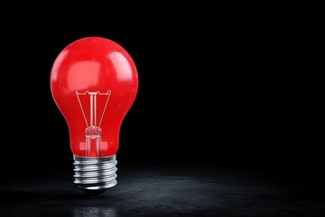 Red Light Bulb Glowing in Darkness with Black Background