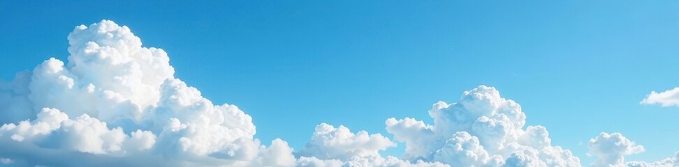 White cloud clusters drift lazily across the sky, blue, peaceful, white